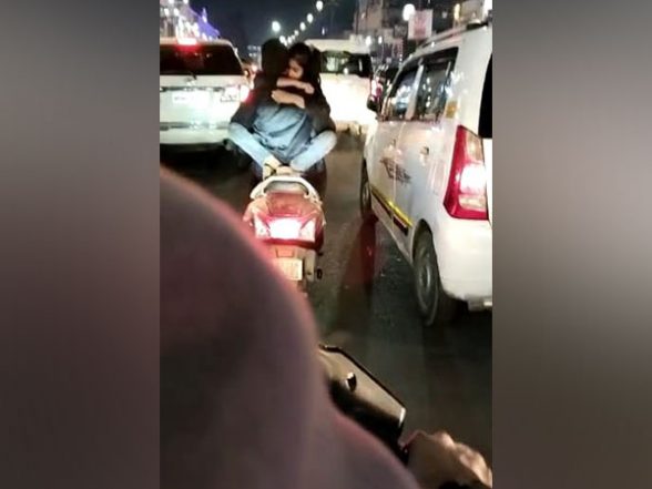 PDA on Two-Wheeler: Viral Video Shows Duo Hugging While Riding Scooty in Lucknow's Hazratganj, Probe Underway