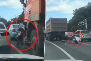 Viral Video: Biker Dodges Death After Coming Under Truck While Crossing Lane on Packed Road